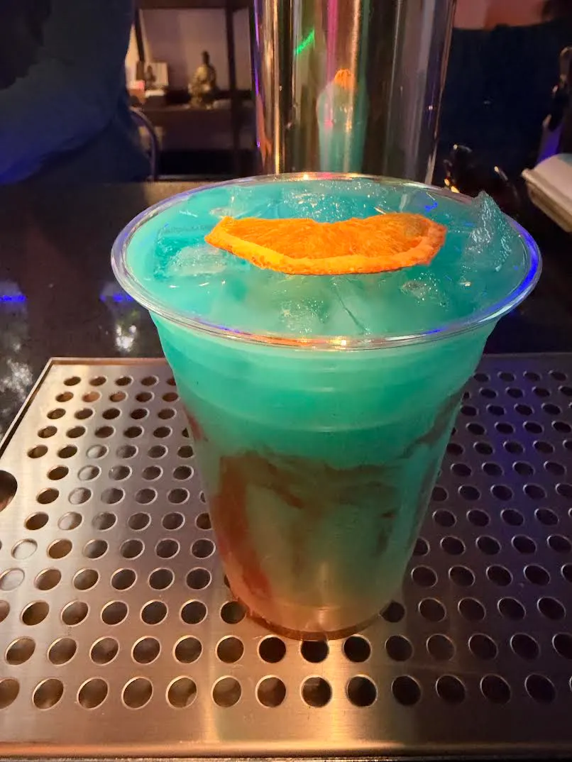 A bright blue kavatail layered with red over ice