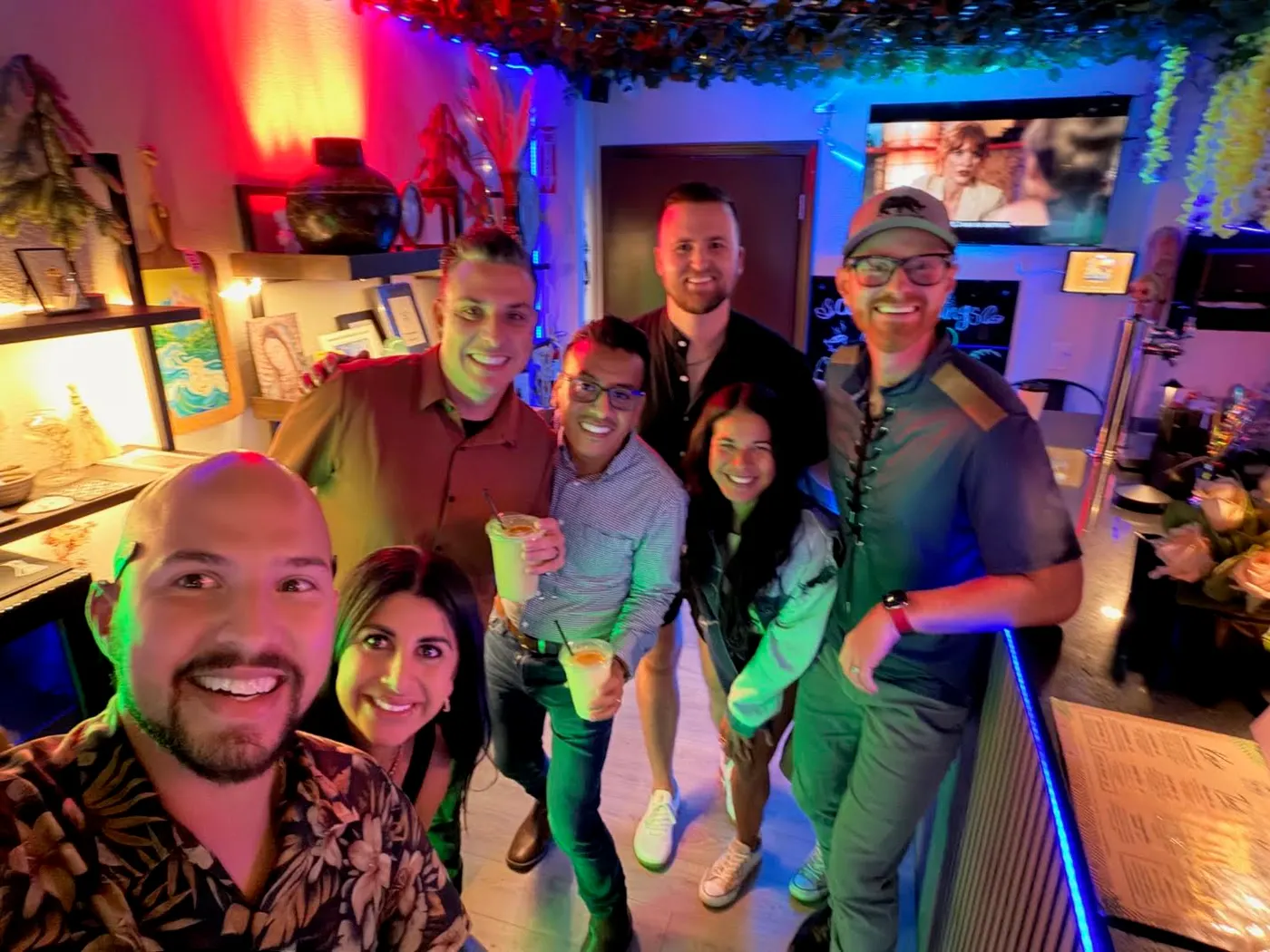 A group of friends smiling together inside Tribu Kava House