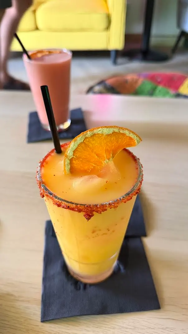 A golden kavatail with a chili-lime rim and dried orange